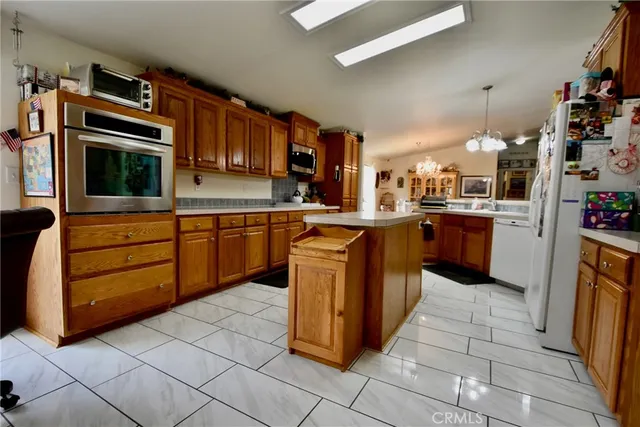 a kitchen with stainless steel appliances granite countertop a stove sink and cabinets