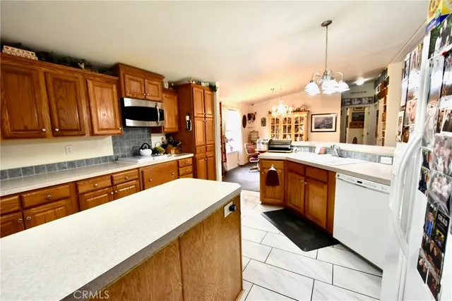 a kitchen with a sink stainless steel appliances and white cabinets