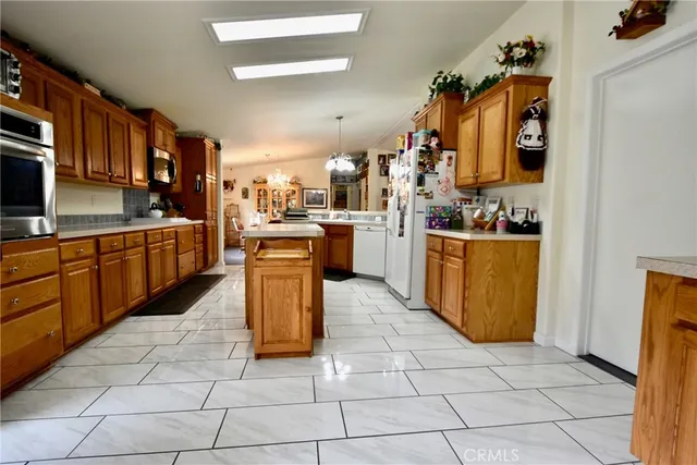 a kitchen with stainless steel appliances granite countertop a stove top oven a sink a counter top space and cabinets