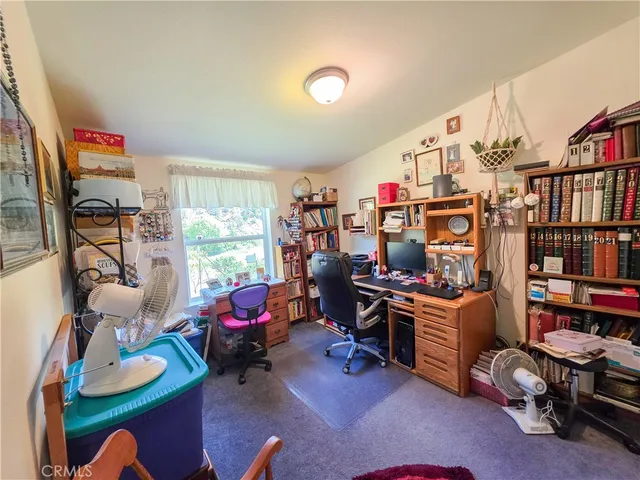 a bedroom with furniture toys and a large window