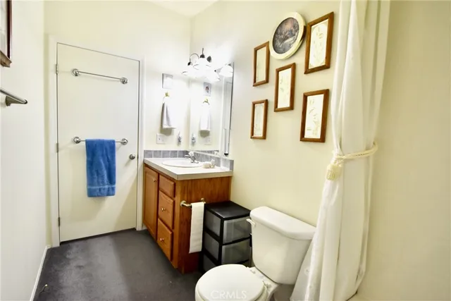 a bathroom with a toilet a sink and a mirror