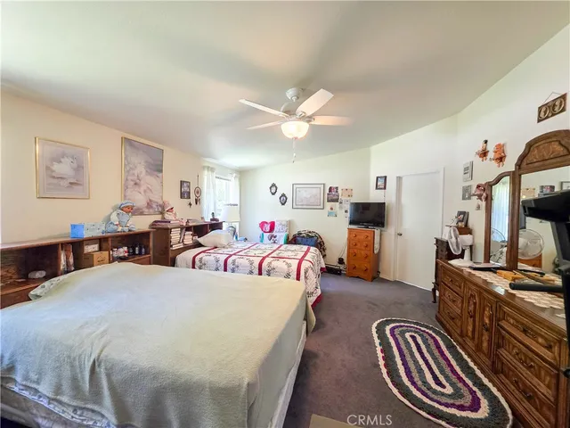 a bed room with bed and a flat screen tv