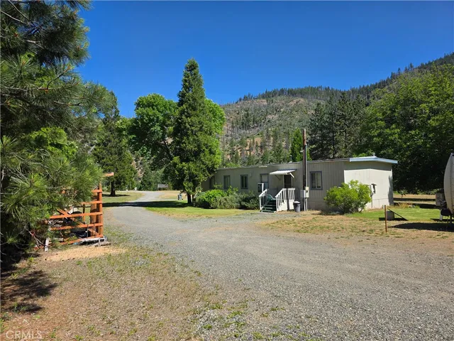 a view of a kitchen with kitchen island stainless steel appliances refrigerator dining table and chairs