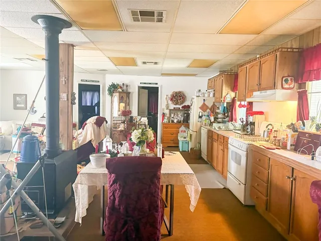 an aerial view of a house with a yard and lake view