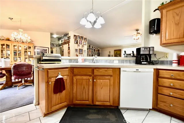 a kitchen with stainless steel appliances granite countertop a stove top oven a sink and dishwasher