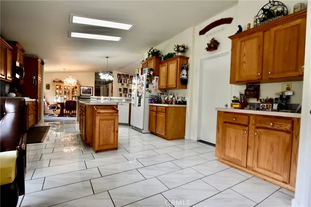 a kitchen with stainless steel appliances granite countertop a stove top oven a sink counter space and cabinets