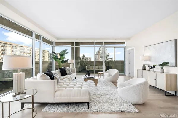a living room with furniture and large windows