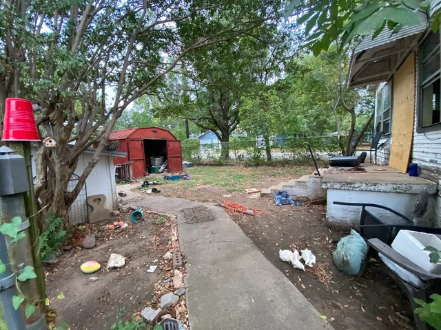 a view of a backyard with sitting area