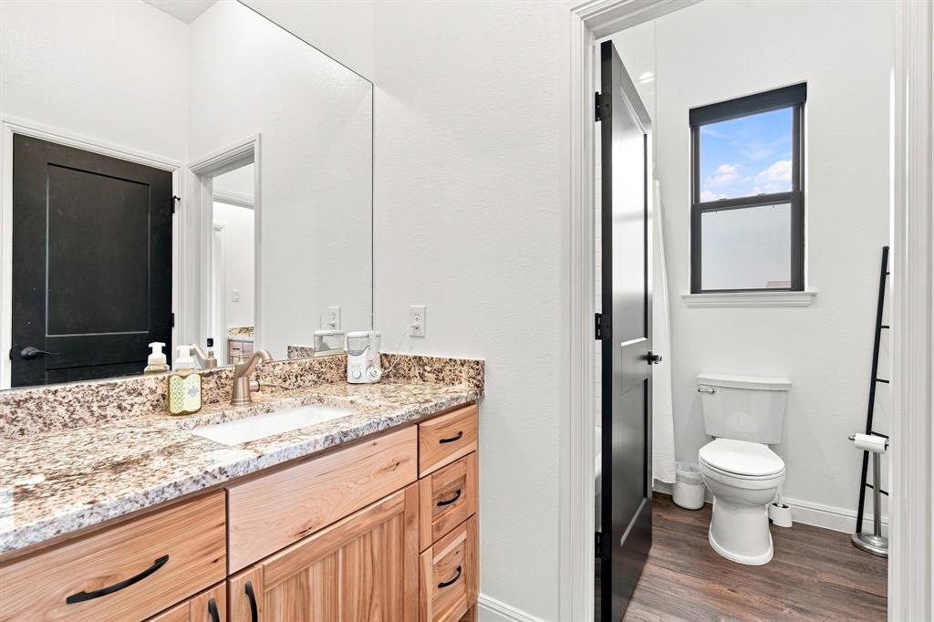 140 Lone Elm Road Midlothian, TX 76065 - Photo 23 of 36 Guest bathroom with natural woodwork and granite counter tops.