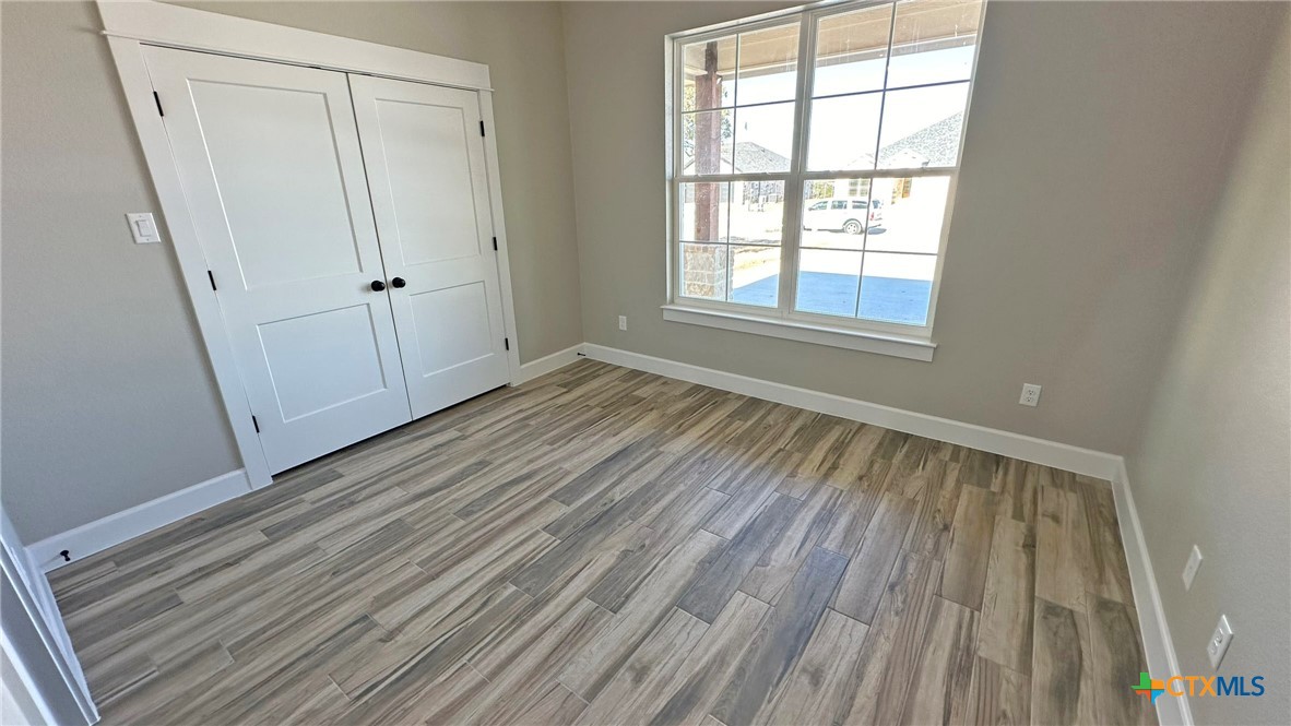 115 Overlook Trail Copperas Cove, TX 76522 - Photo 20 of 34 a view of a room with wooden floor and white walls