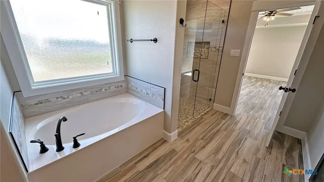 a bathroom with a tub and shower