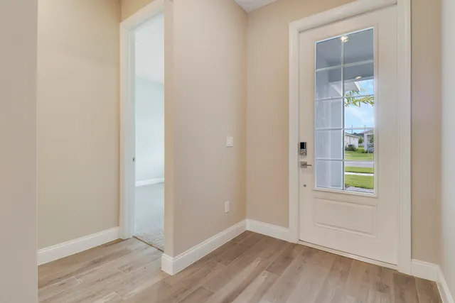 a view of a hallway with wooden floor