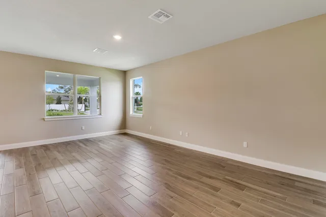 a view of a room with wooden floor and window