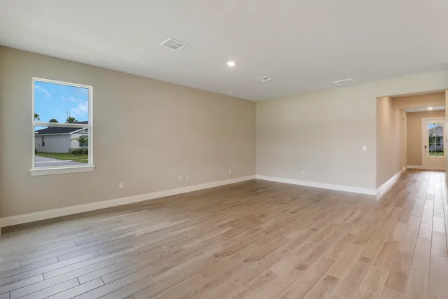 a view of a kitchen with a sink and wooden floor
