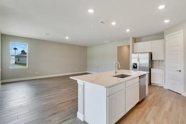 a kitchen with cabinets and stainless steel appliances