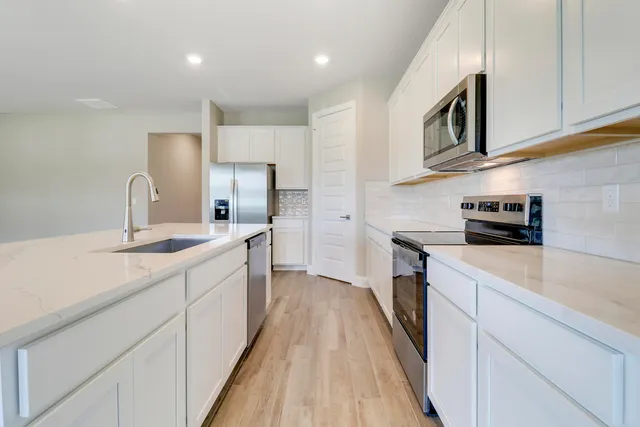 a kitchen with counter top space and two sink