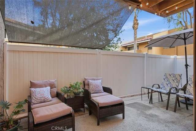 a view of a patio with a table and chairs