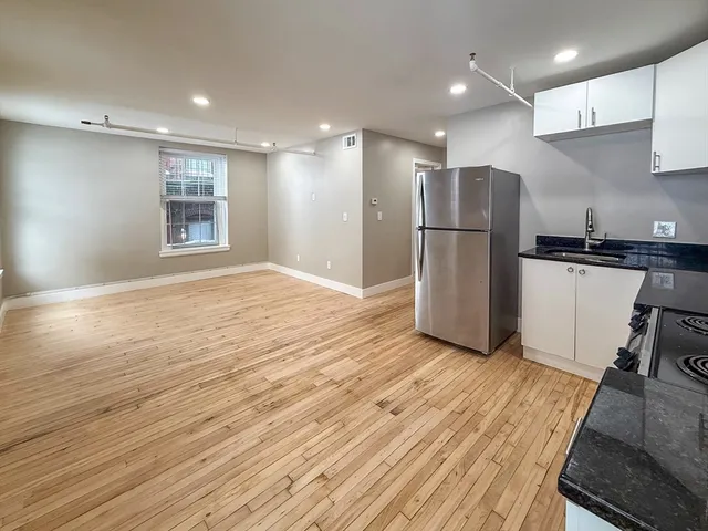a view of kitchen with refrigerator microwave and stove
