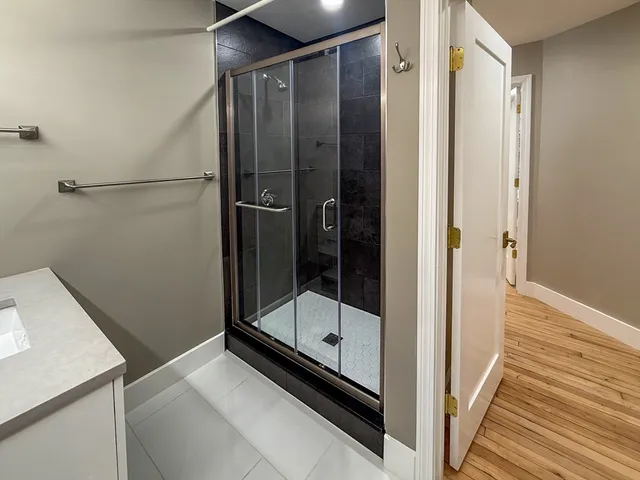 a bathroom with a shower and a sink