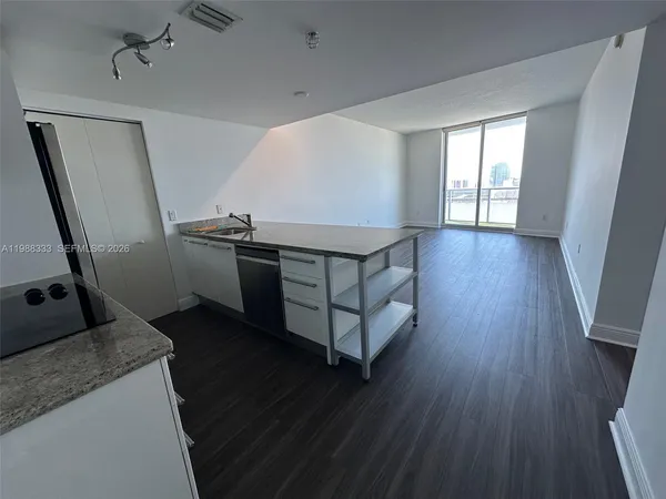 a spacious bathroom with sink and mirror