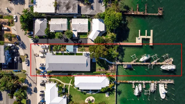 an aerial view of a house with a garden and a swimming pool