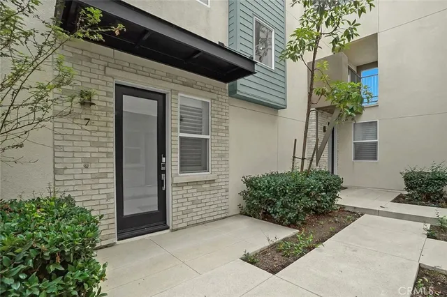 a potted plant sitting in front of a house