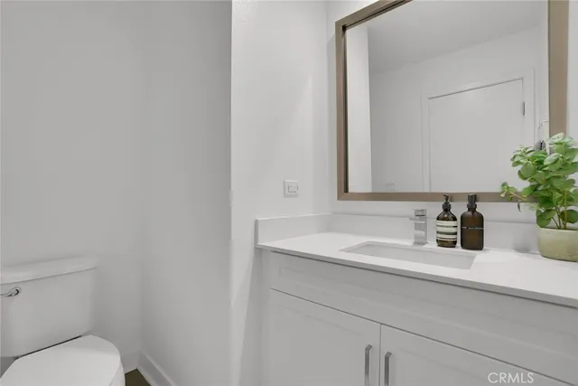 a bedroom with a bed and a night stand