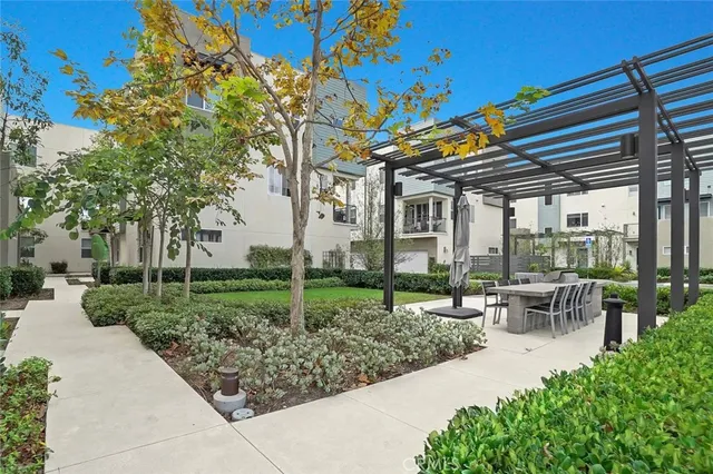 a view of a patio with table and chairs and potted plants