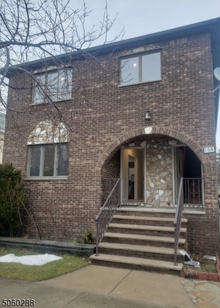 164 Main Street, Unit 2 Garfield, NJ 07026 - Photo 1 of 24 a front view of a house with garage