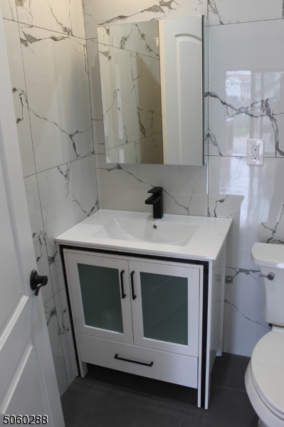 164 Main Street, Unit 2 Garfield, NJ 07026 - Photo 12 of 24 a bathroom with a sink a toilet and a shower