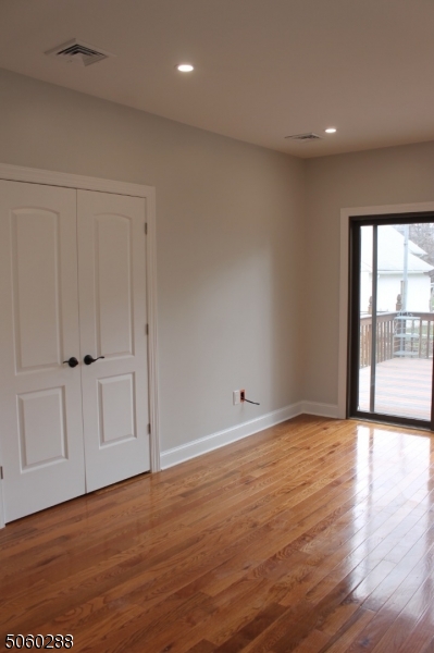 164 Main Street, Unit 2 Garfield, NJ 07026 - Photo 14 of 24 a view of an empty room with wooden floor and a window