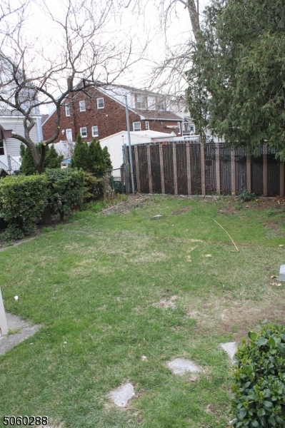 164 Main Street, Unit 2 Garfield, NJ 07026 - Photo 18 of 24 a backyard of a house with lots of green space