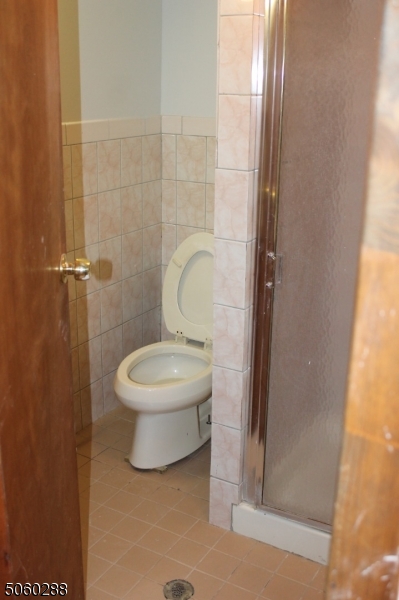 164 Main Street, Unit 2 Garfield, NJ 07026 - Photo 19 of 24 a bathroom with a toilet and a shower