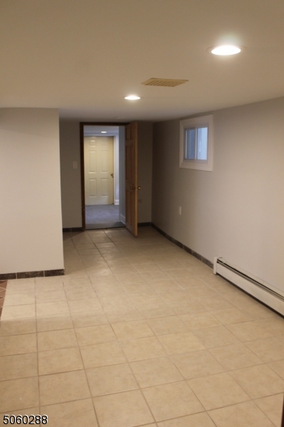 164 Main Street, Unit 2 Garfield, NJ 07026 - Photo 22 of 24 a view of an empty room with a window
