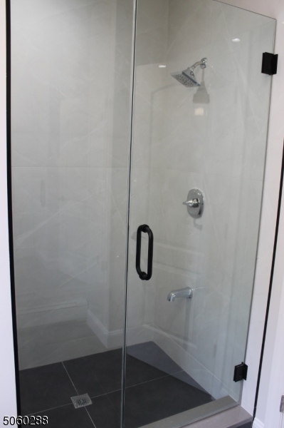 164 Main Street, Unit 2 Garfield, NJ 07026 - Photo 7 of 24 a bathroom with a glass shower door