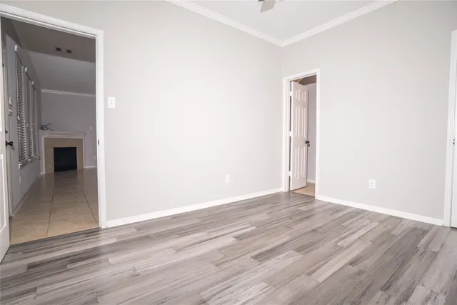 a view of an empty room with wooden floor