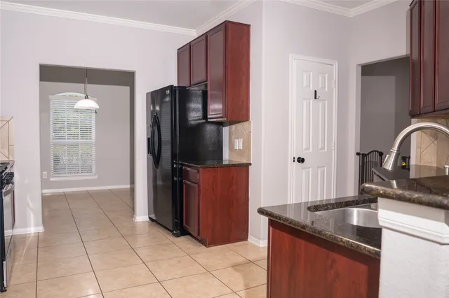 a kitchen with stainless steel appliances granite countertop a refrigerator and a sink