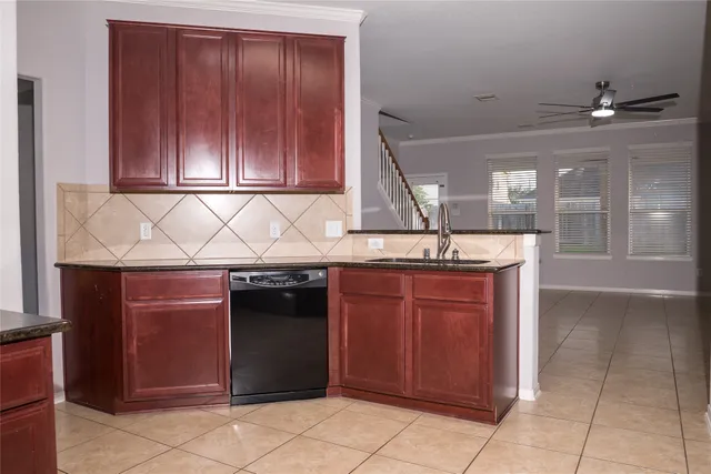 a kitchen with granite countertop a sink and cabinets