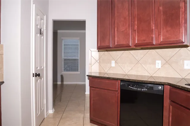 a kitchen with granite countertop a sink and cabinets