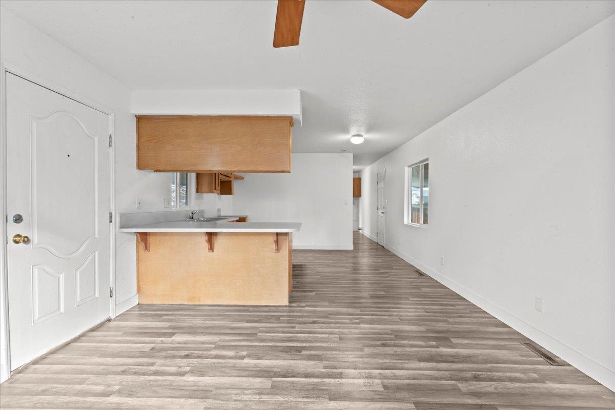 1249 Magic Sands Way Turlock, CA 95380 - Photo 7 of 13 a view of a kitchen from the hallway