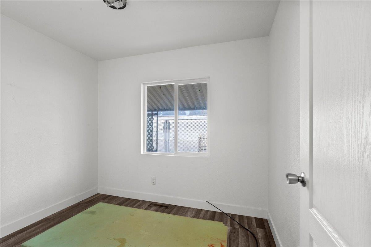 1249 Magic Sands Way Turlock, CA 95380 - Photo 10 of 13 a view of a room with rack on the wall and a window