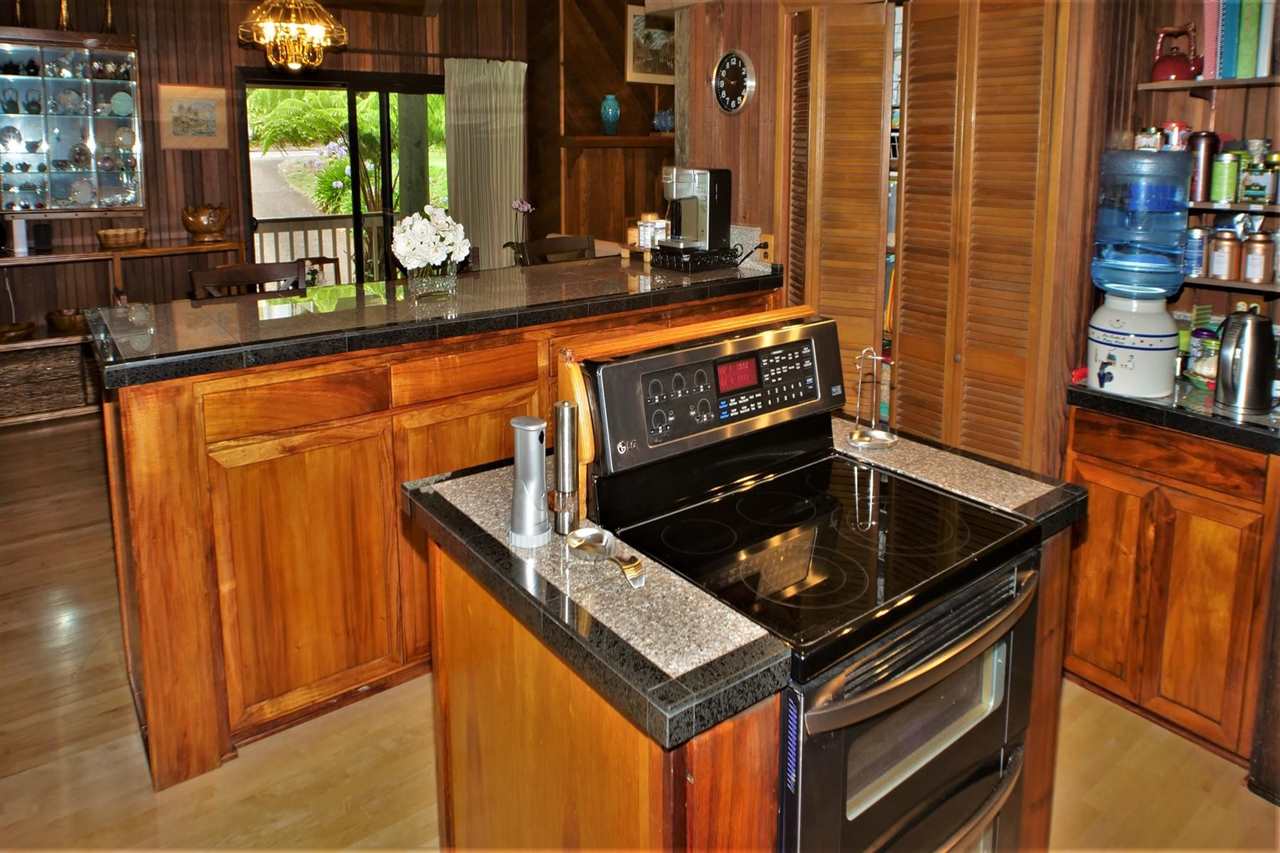 26 Manu Street Kula, HI 96790 - Photo 11 of 30 a kitchen with stainless steel appliances a stove and a microwave