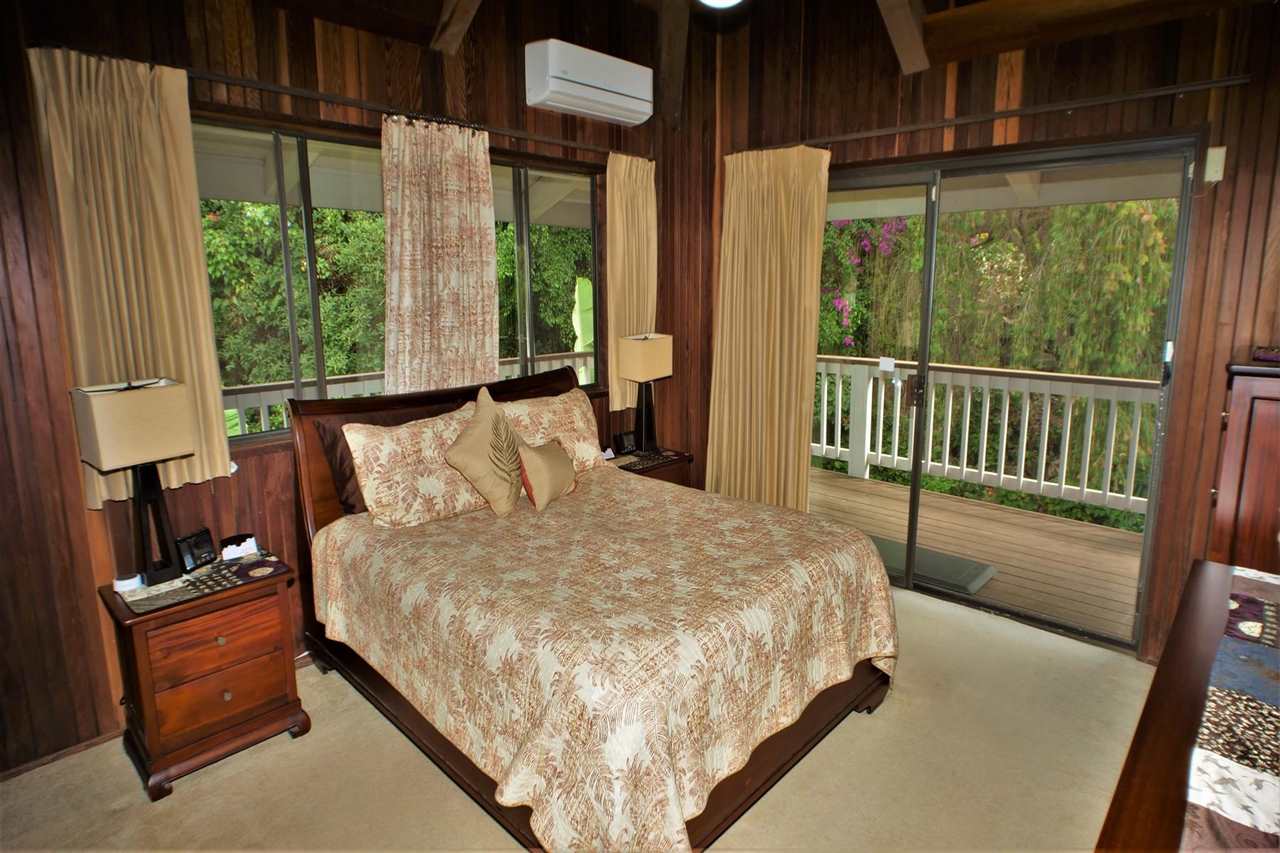 26 Manu Street Kula, HI 96790 - Photo 12 of 30 a bed sitting in a bedroom next to a window