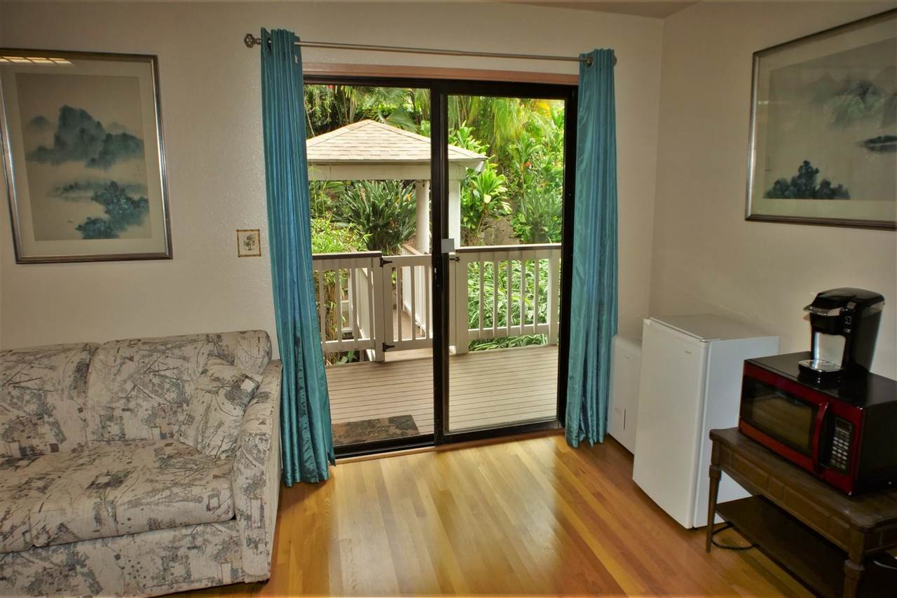 26 Manu Street Kula, HI 96790 - Photo 20 of 30 a view of a bedroom with wooden floor and a bed