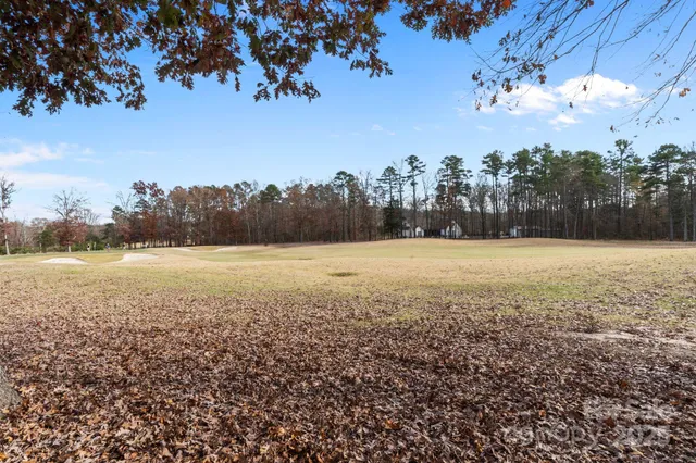 a spacious bedroom with a bed lamp closet and large window