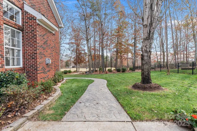 a dining room with wooden floor a chandelier a wooden table and chairs