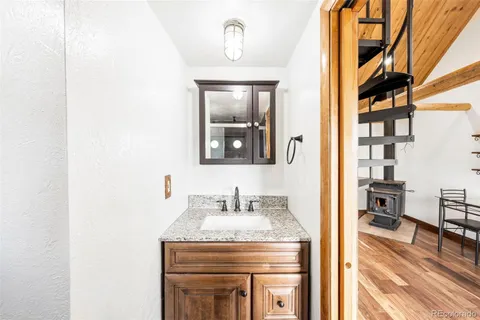 a en suite bathroom with a granite countertop sink and a mirror