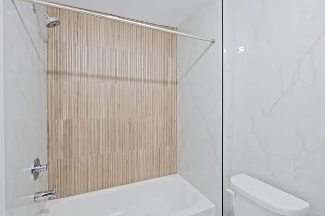 a bathroom with a shower and a toilet