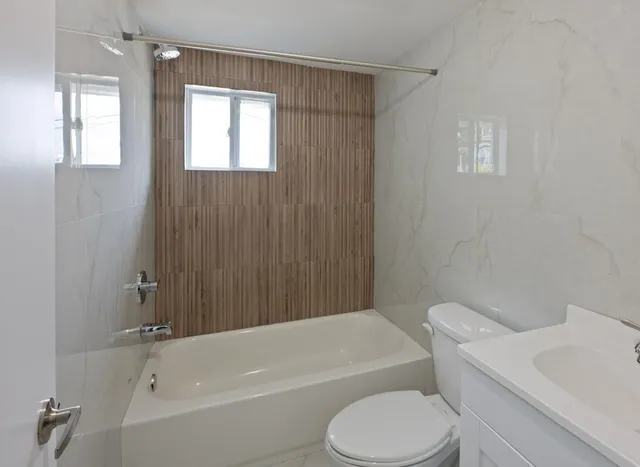 a bathroom with a toilet and a bathtub