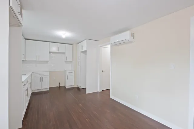 a view of a kitchen with wooden floor